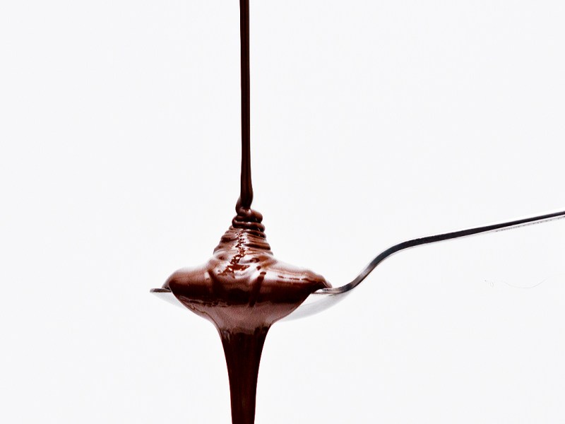 Melting chocolate, falling into spoon